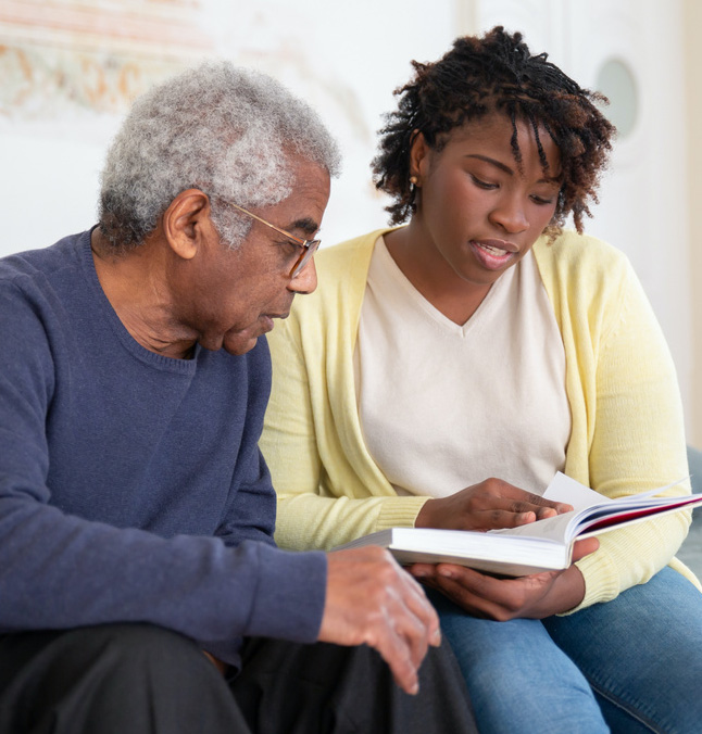 Woman reading page to man